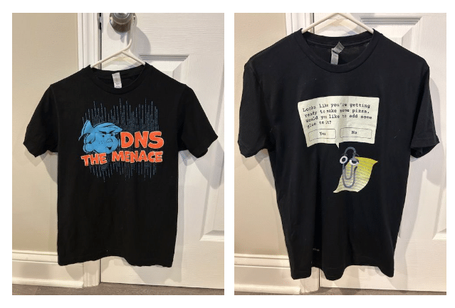 Two black geek t-shirts: one with “DNS The Menace” design, the other featuring Microsoft Clippy with a pop-up joke